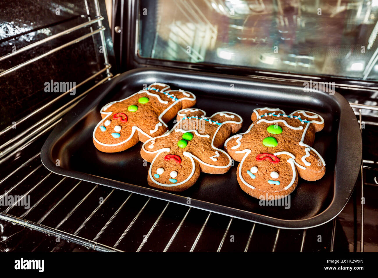 Baking Gingerbread man in the oven. Cooking in the oven. Stock Photo