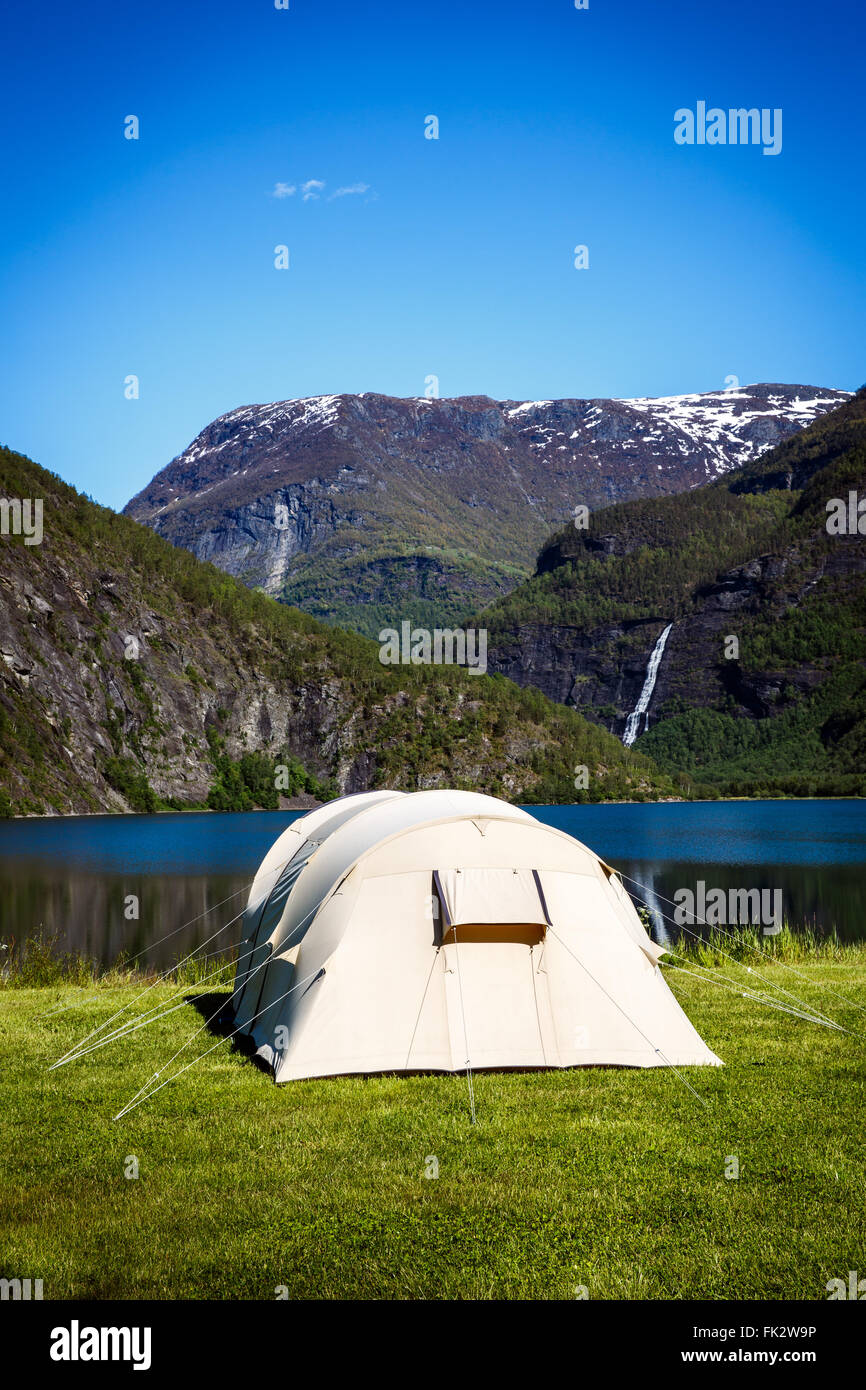 Camping. Holiday in Norway. Tourist tent on the shore of the lake. Stock Photo