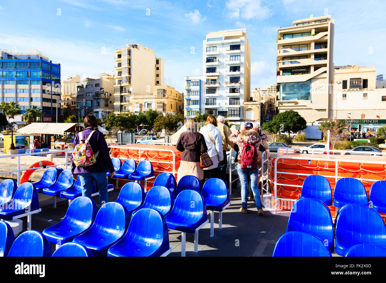 Passengers disembark from the Sliema - Valletta ferry at Sliema. Stock Photo