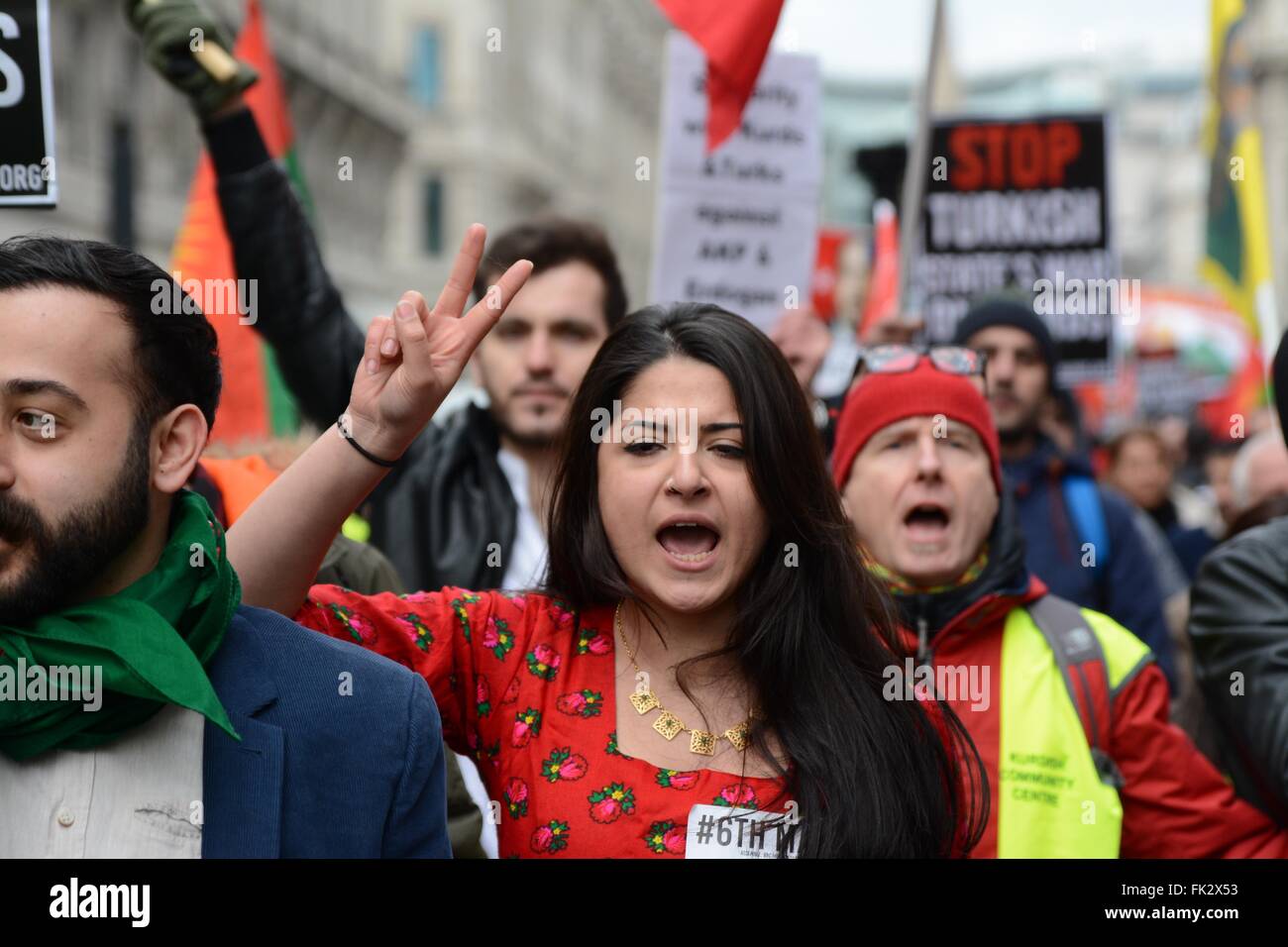 London, UK. 6th March 2016. Demonstrator holds 'v for victory' pose whilst in traditional Kurdish clothing. Credit:  Marc Ward/Alamy Live News Stock Photo