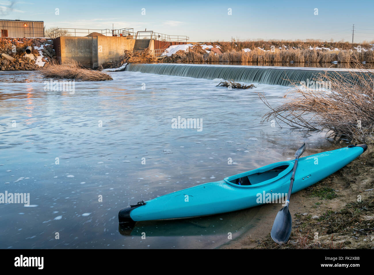 blue whitewater kayak and river diversion dam - St Vrain Creek near Platteville in northern Colorado Stock Photo