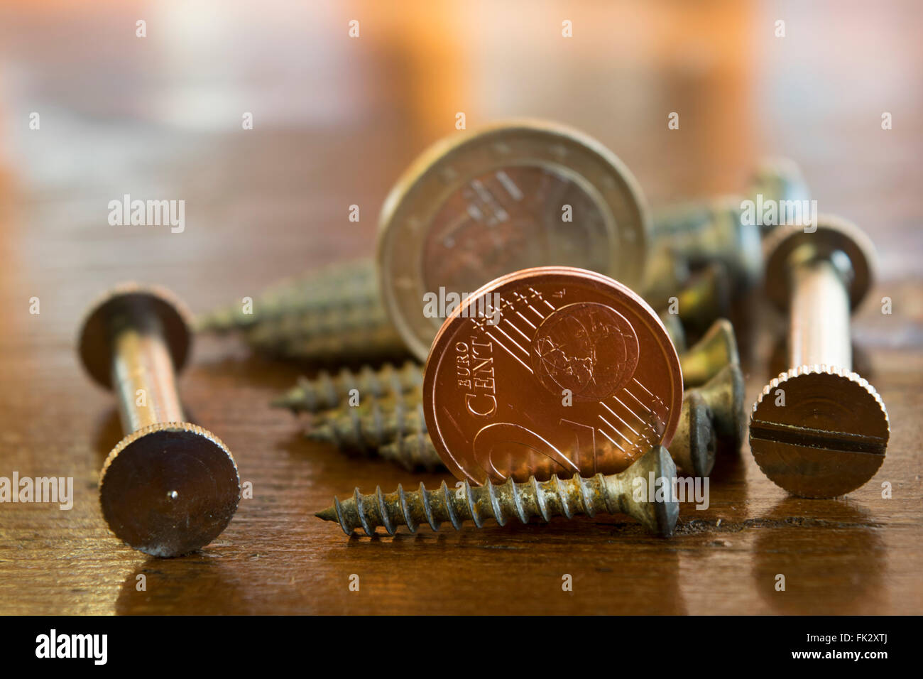 screws bolts and two cent  to symbolize the concept of manual work , professions and monetary   profits Stock Photo
