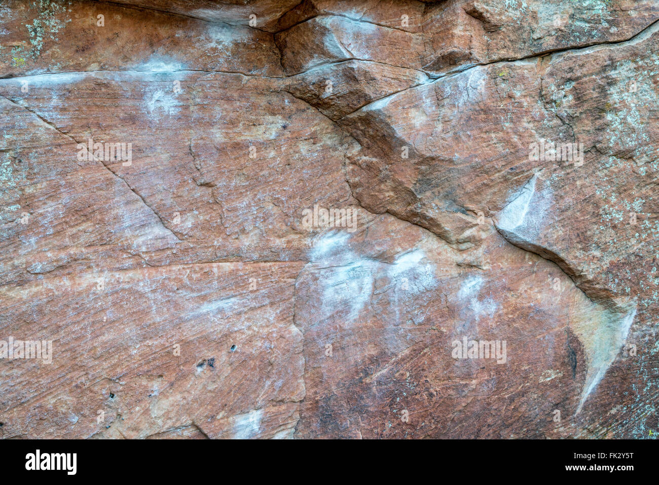 sandstone climbing wall with white chalk marks and lichen Stock Photo