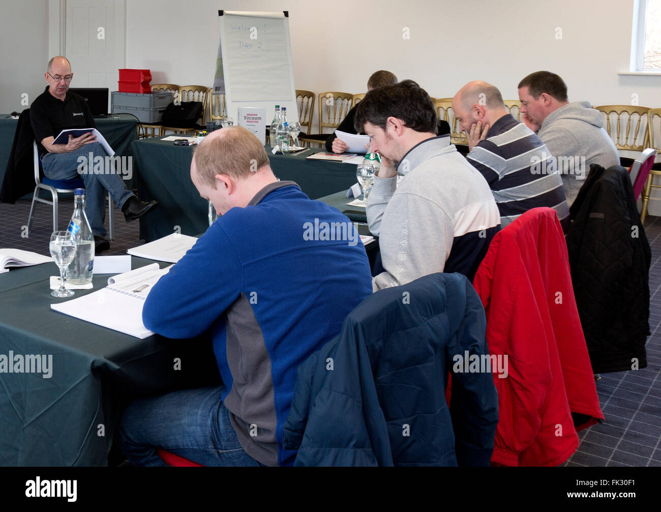 Male adult learners in classroom. University level education. Stock Photo