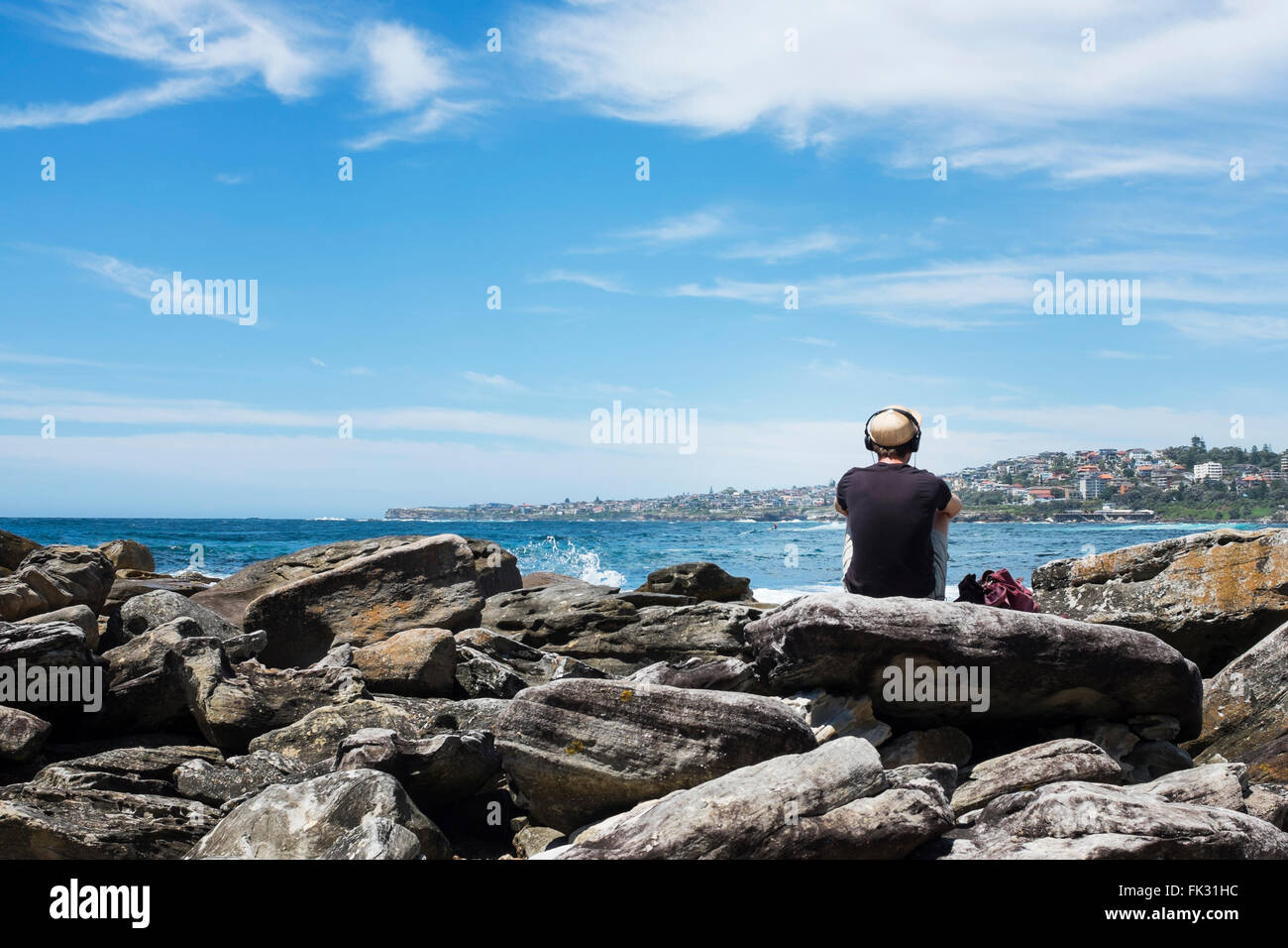 man looking out at the view over the sea, Coogie to Bondie walk, Sydney, NSW, Australia Stock Photo
