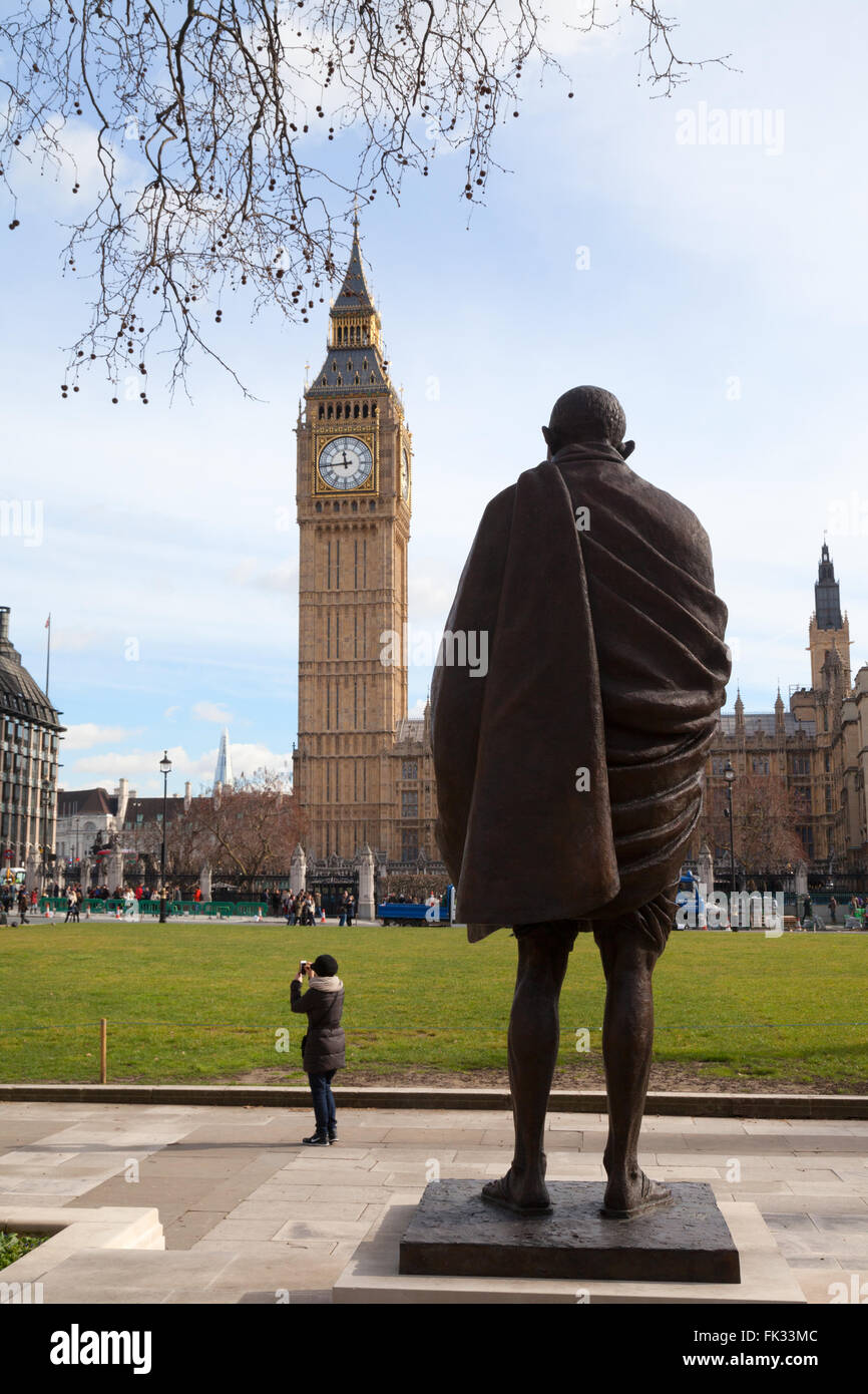 The statue of Mahatma Ghandi, and Big Ben, Parliament Square, London UK Stock Photo