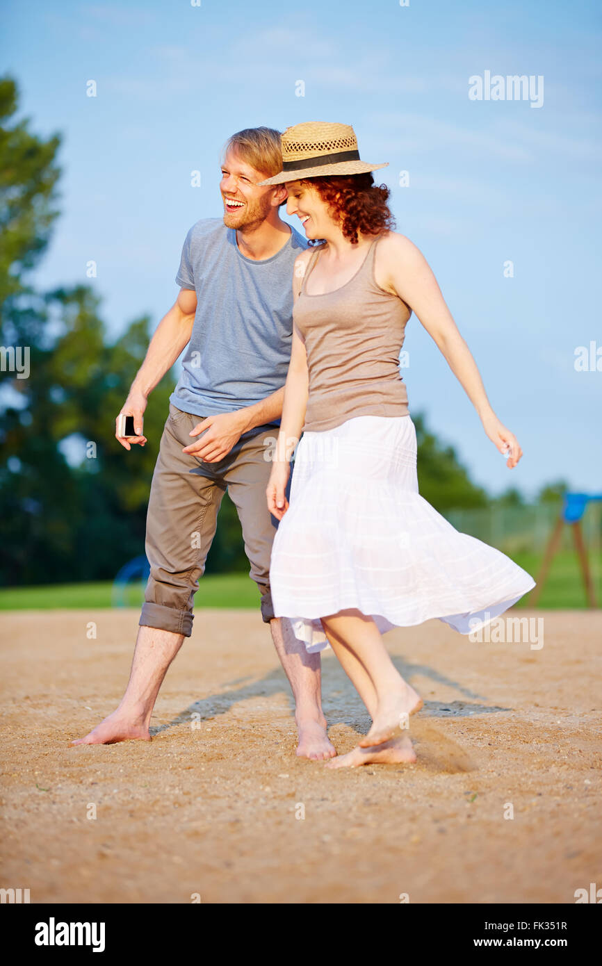 Happy couple taking a walk together at beach on vacation Stock Photo