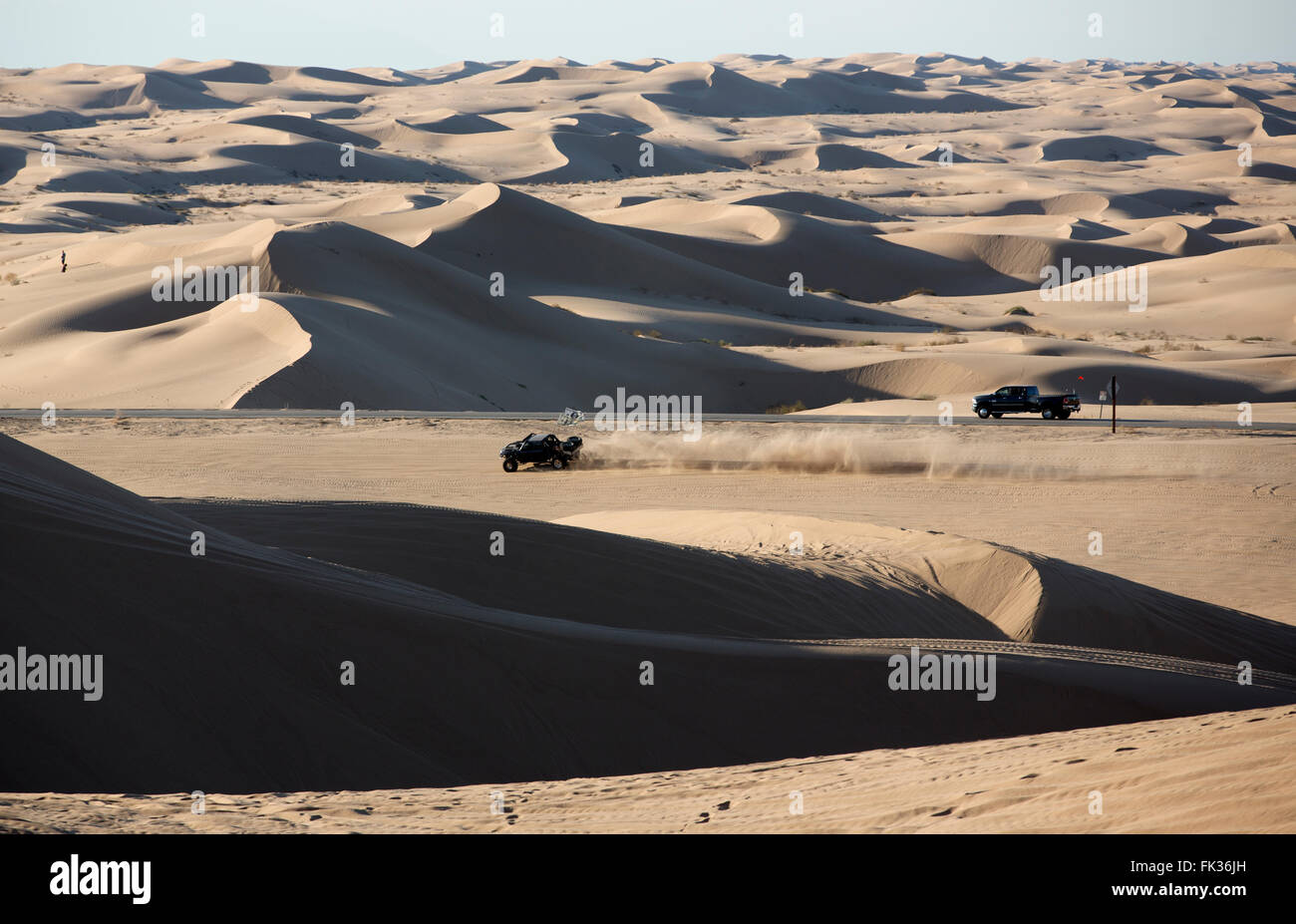 An off road vehicle and a truck on highway 78 in Imperial Sand Dunes Recreation Area, California USA Stock Photo