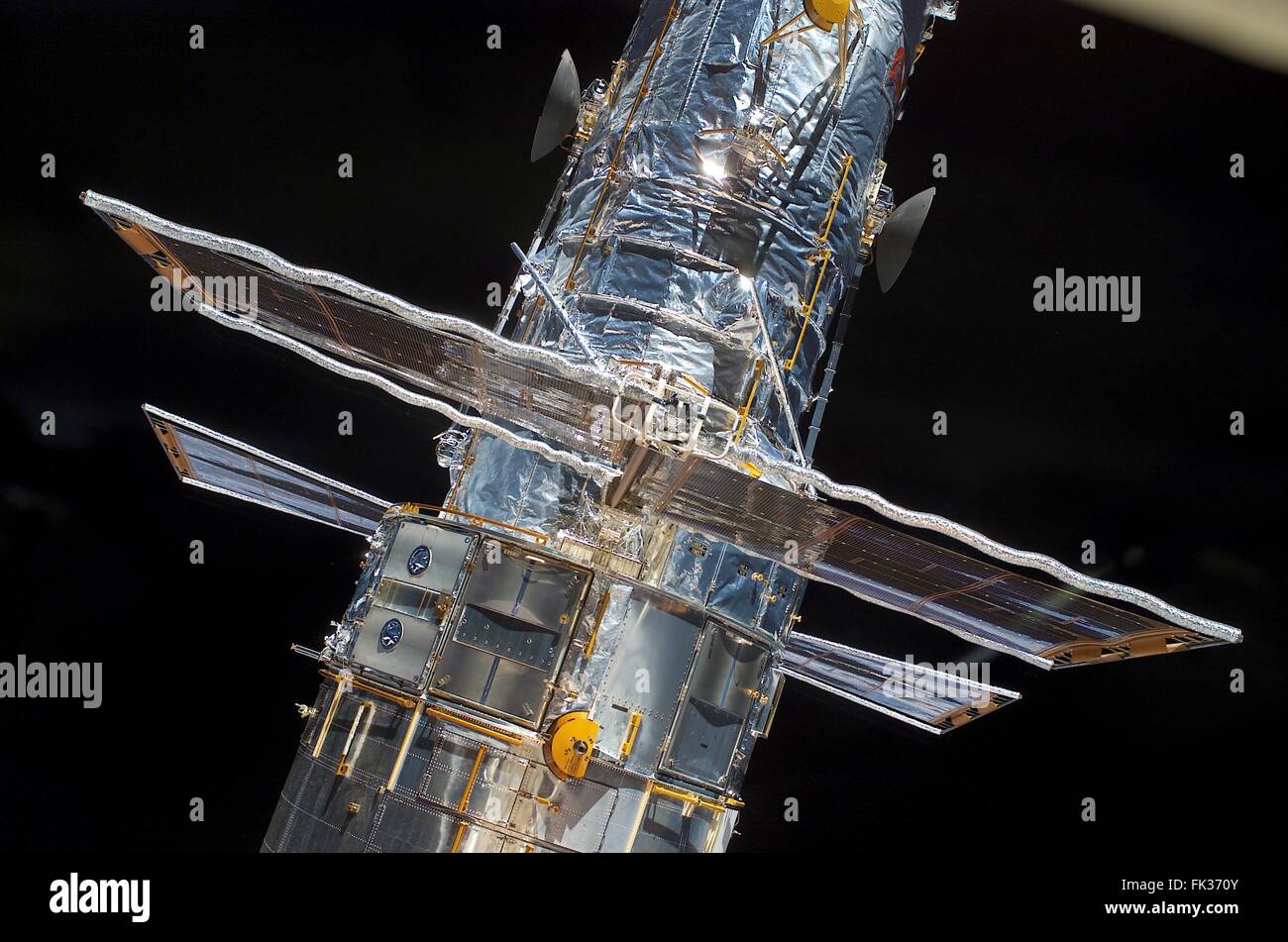 The Hubble Space Telescope in the cargo bay of the Space Shuttle Columbia after the crew of STS-109 grabbed the floating observatory with the robotic arm to begin the process of replacing the solar array March 3, 2002 in Earth Orbit. Stock Photo