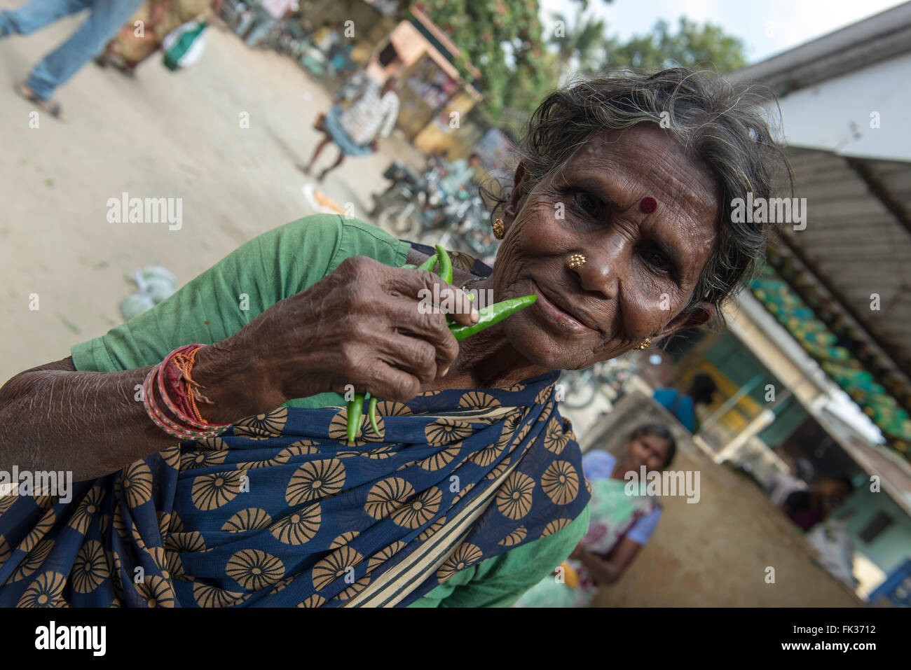 Old Lady Eating Green Chilli, Mathalangulam, Tiruvannamalai Stock Photo