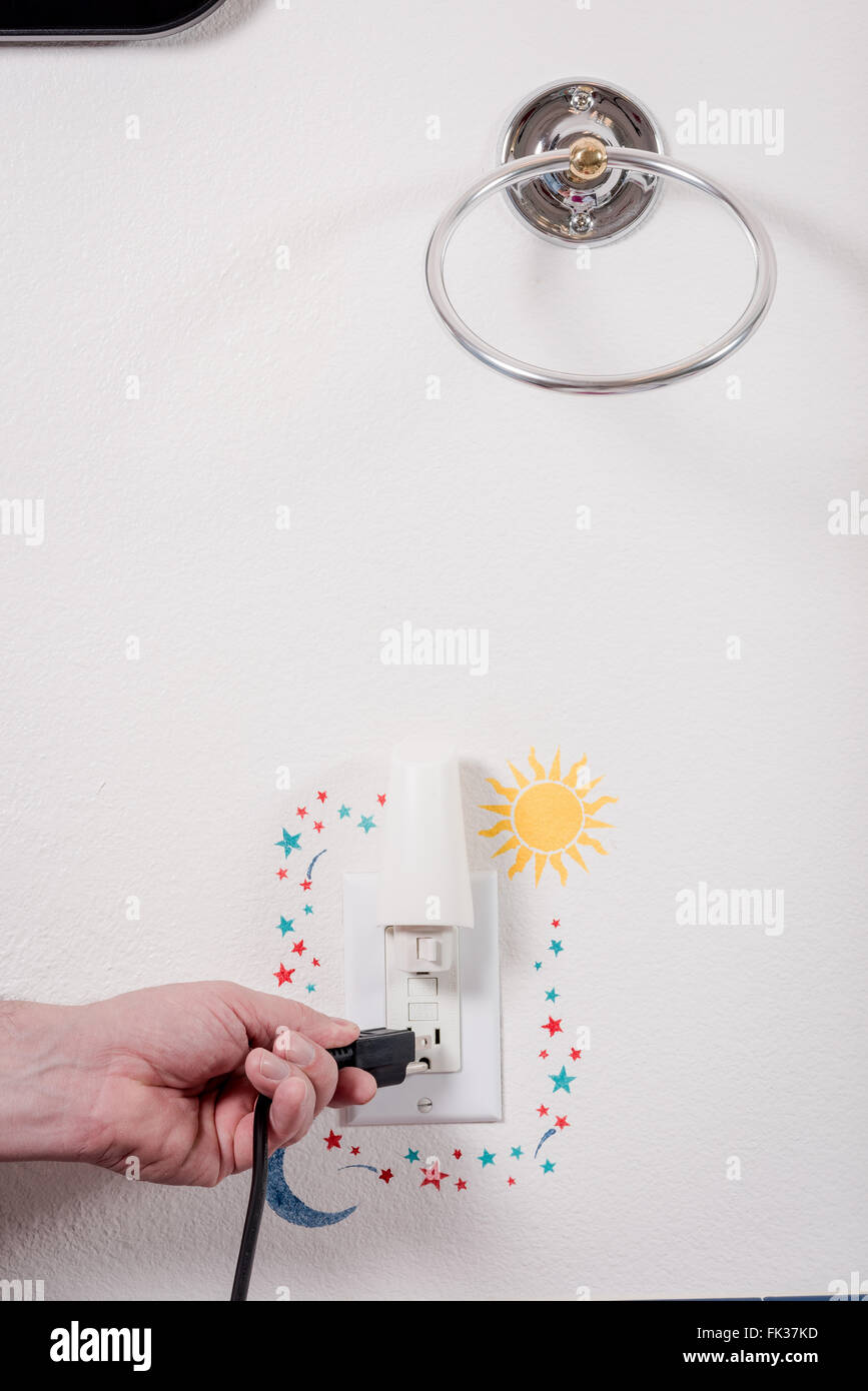 Using an electrical outlet in a home bathroom Stock Photo Alamy