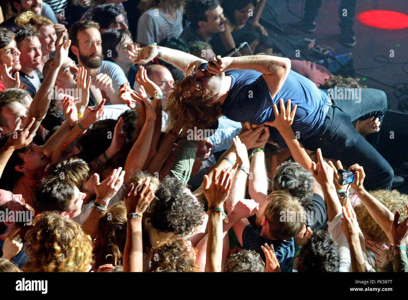 BARCELONA - MAY 30: The guitar player of Ty Segall (band) performs above the spectators (crowd surfing or mosh pit). Stock Photo