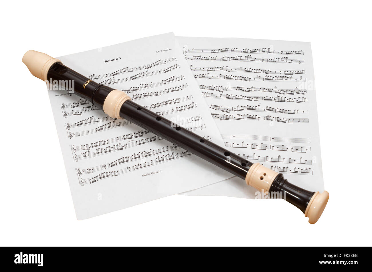 Aulos alto or treble recorder with a background of sheet music, a Telemann sonata,  isolated on a white background Stock Photo