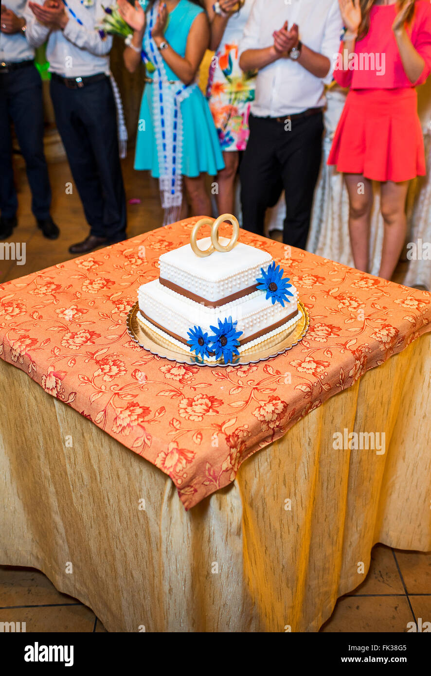 white floral wedding cake on restaurant interior background Stock Photo