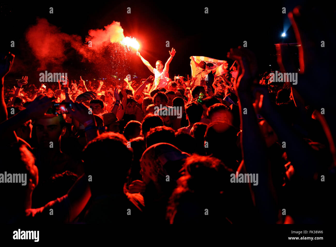 BENICASSIM, SPAIN - JULY 18: Man from the crowd with a burning flare at FIB Festival on July 18, 2014 in Benicassim, Spain. Stock Photo