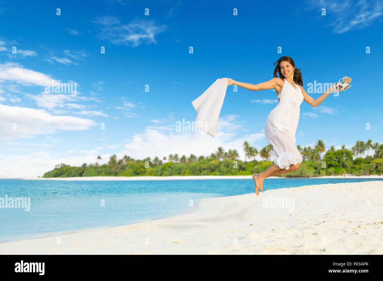 Beautiful girl jumping on tropical beach Stock Photo