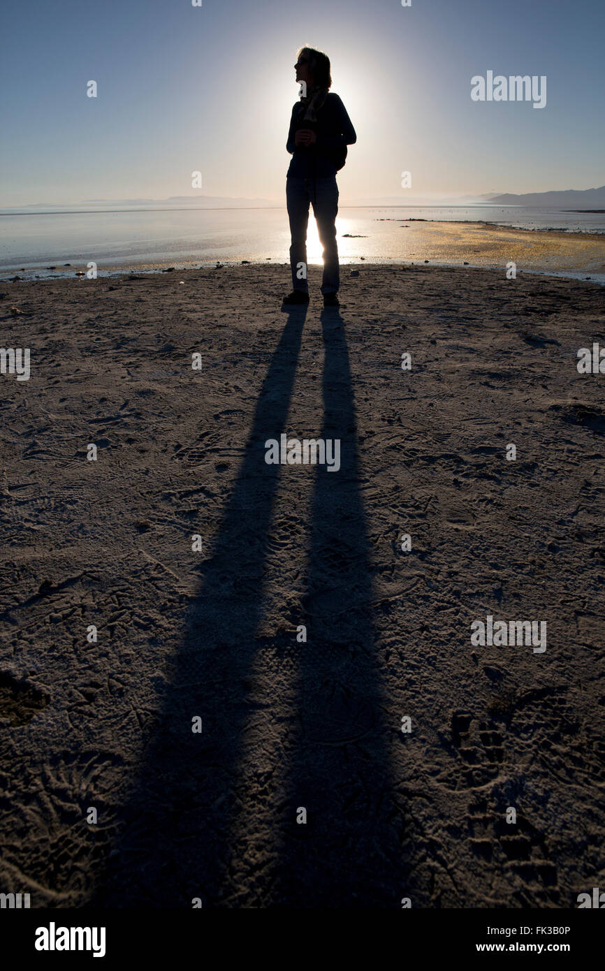A woman standing on the shore of Salton Sea, California, USA Stock Photo