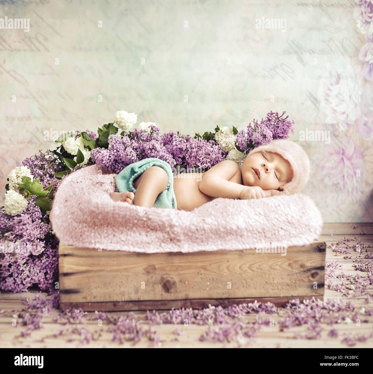 Sleeping toddler lying on purple flowers and blanket Stock Photo Alamy