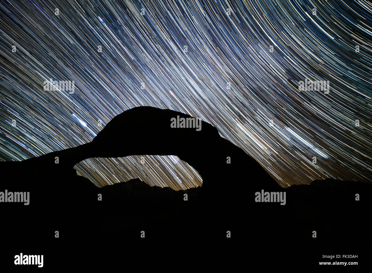 Star trails and the Mobius Arch in the Alabama Hills Recreation Area near Lone Pine, California in the High Sierra along US 395. Stock Photo
