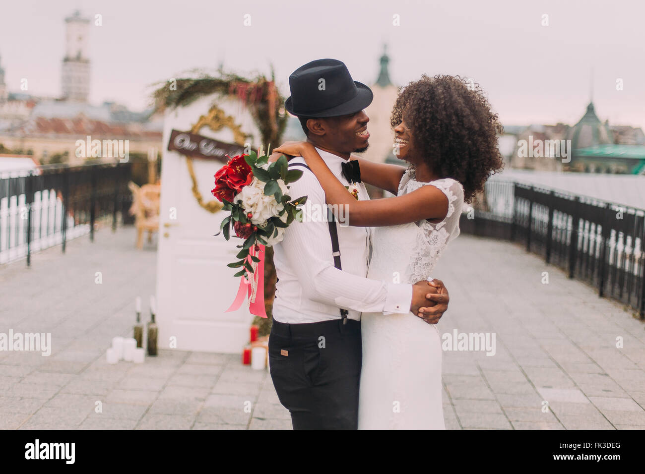 Stylish african groom in hat and his 