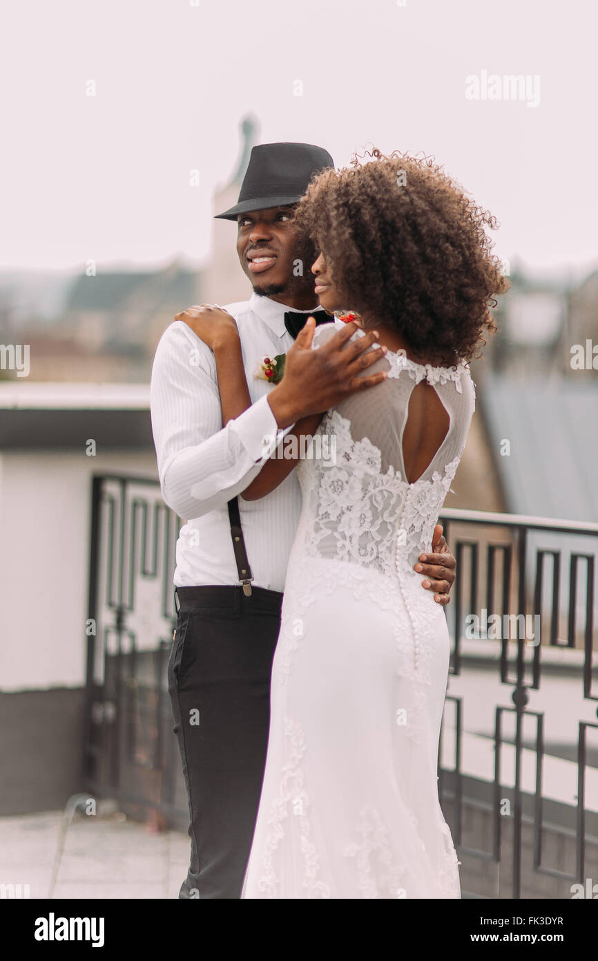 Happy black newlyweds smiling hugging hi-res stock photography and ...