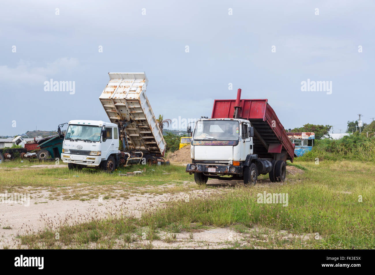 Decaying tipper trucks in Ogg Spencer's Trucking scrapyard, Liberta, south Antigua, Antigua and Barbuda, West Indies Stock Photo
