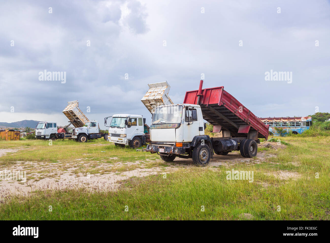Dilapidated tipper trucks in Ogg Spencer's Trucking scrapyard, Liberta, south Antigua, Antigua and Barbuda, West Indies Stock Photo