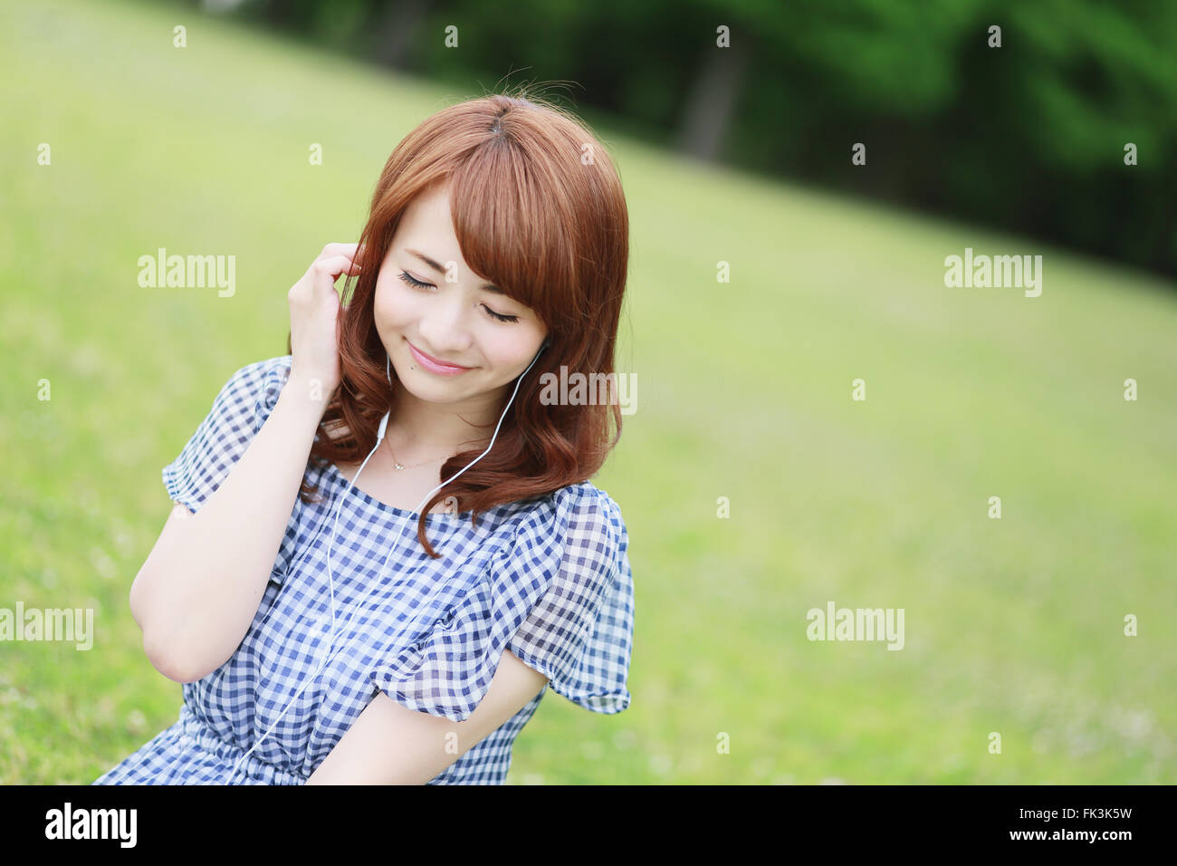 Young attractive Japanese woman in a city park Stock Photo
