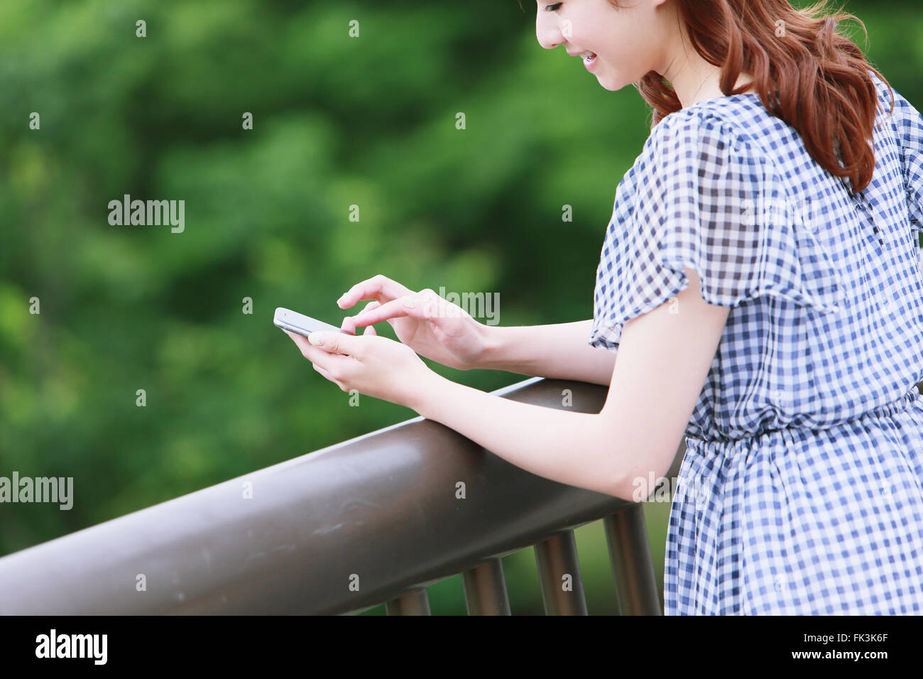 Young attractive Japanese woman in a city park Stock Photo