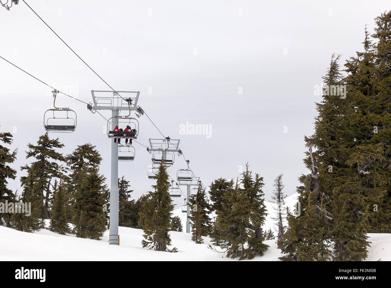 US Forest Service Rescue Crew Personnel Riding Ski Lift up to the Slopes of Mount Hood in Oregon Stock Photo