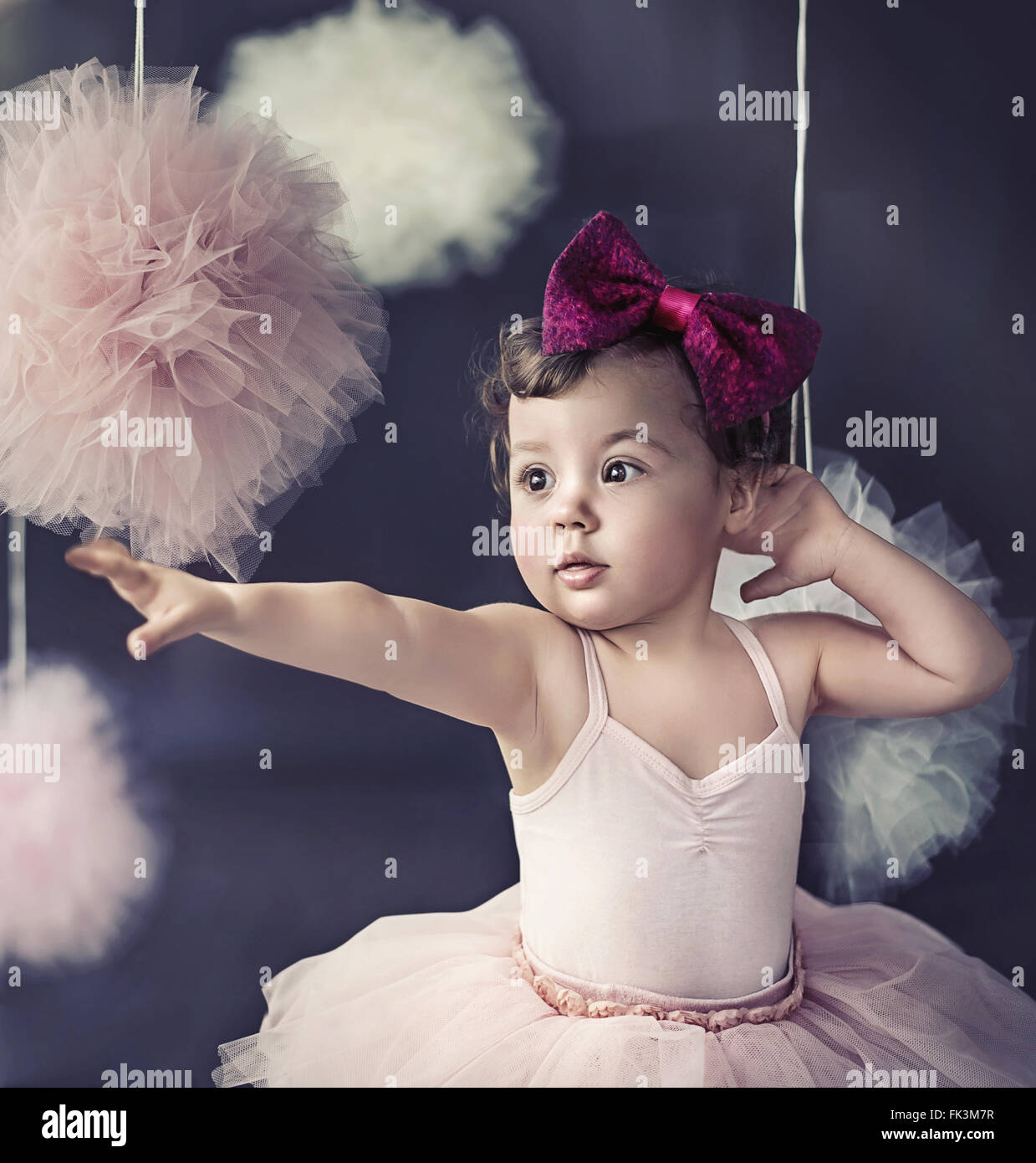 Portrait of a beautiful baby wearing a red polish ribbon Stock Photo