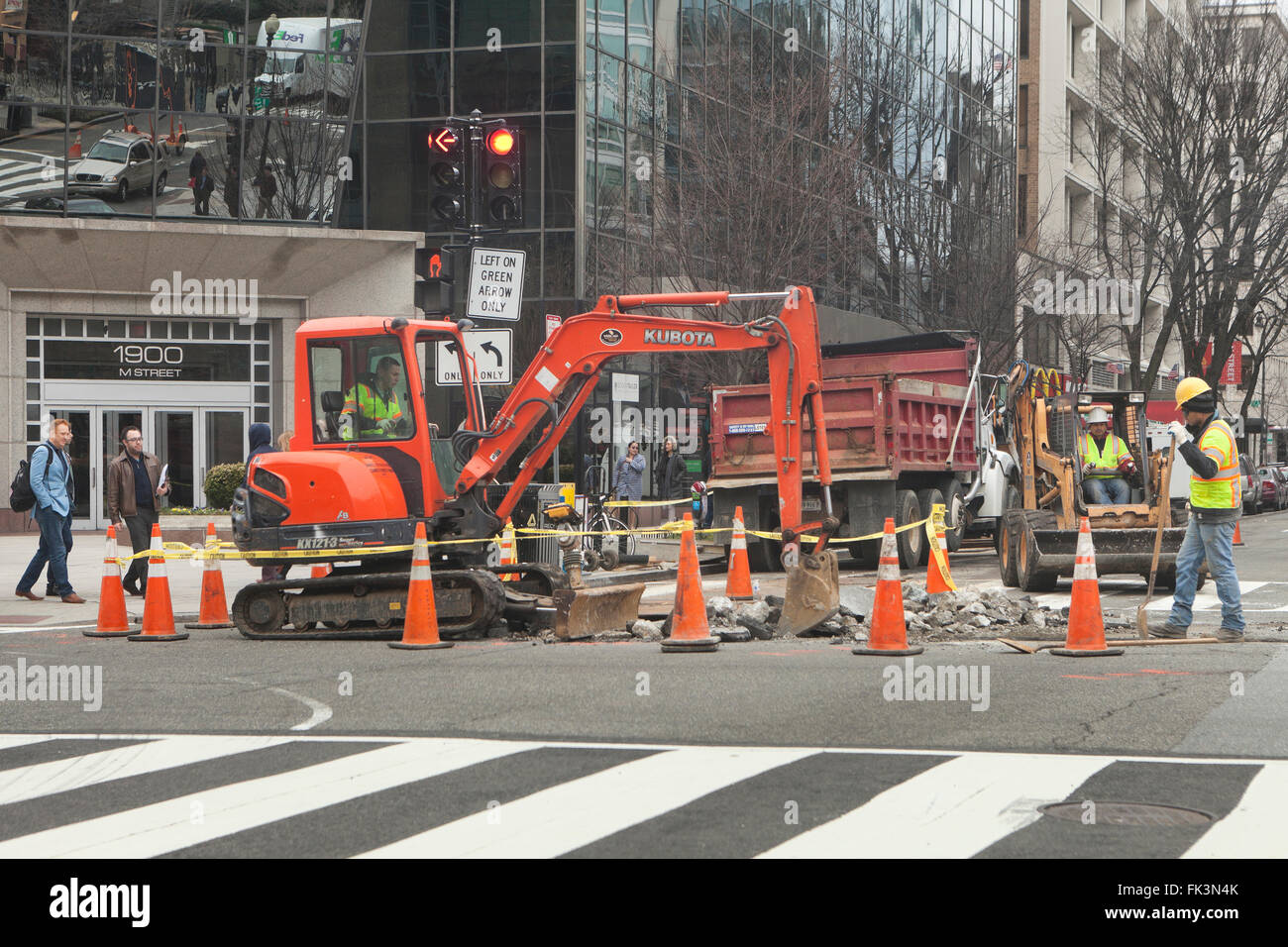 Municipal construction workers using backhoe - USA Stock Photo