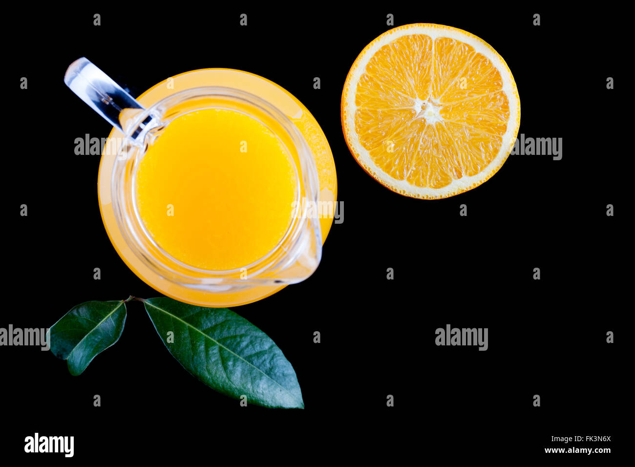 https://c8.alamy.com/comp/FK3N6X/pitcher-of-fresh-orange-juice-on-black-background-top-view-FK3N6X.jpg