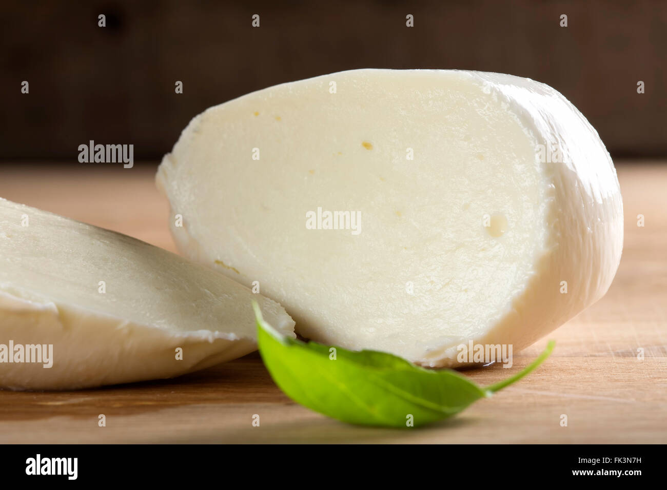 Close up of sliced mozzarella on wooden table Stock Photo