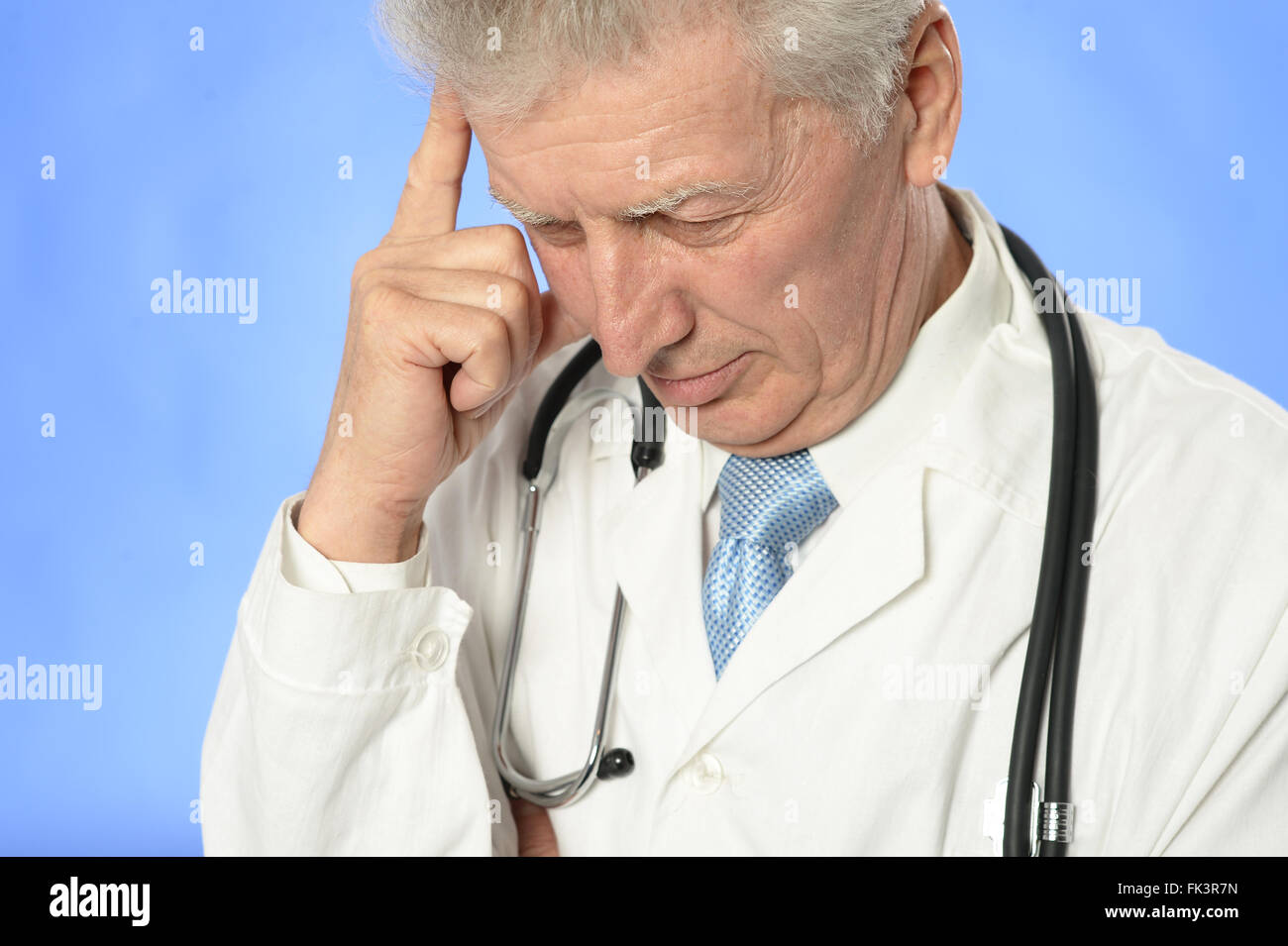 Senior doctor thinking Stock Photo - Alamy