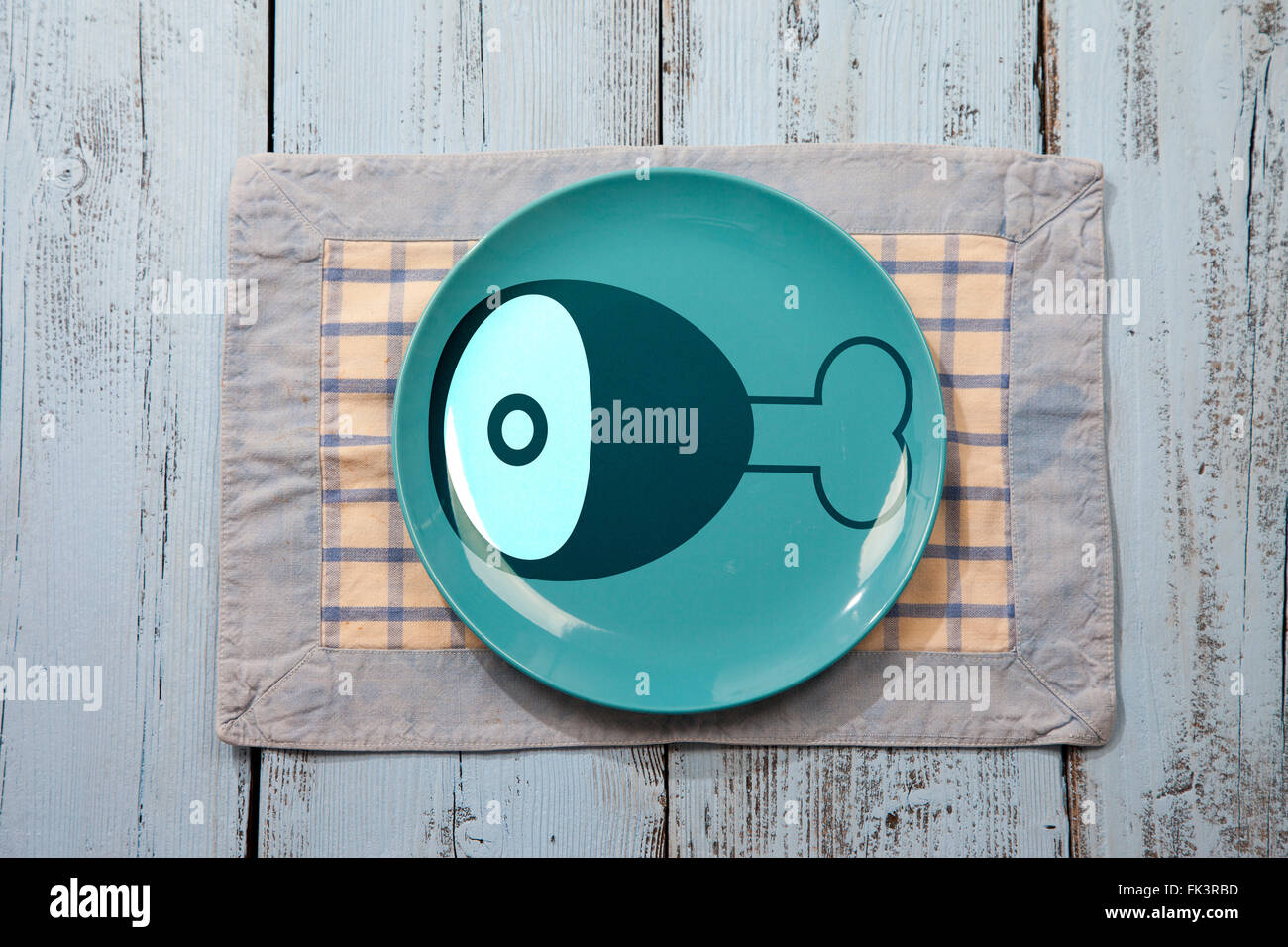 Empty plate with meat icon on light blue wooden background Stock Photo