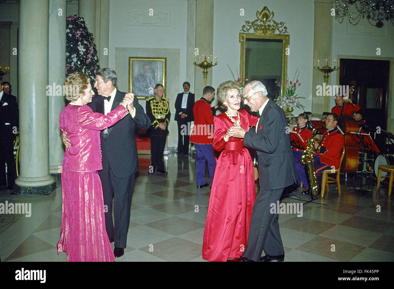United States President Ronald Reagan and Prime Minister Margaret Thatcher of Great Britain share a dance in the Entrance Hall of the the White House in Washington, DC following the dinner in her honor on Wednesday, November 16, 1988. At right their spouses, first lady Nancy Reagan and Denis Thatcher share a dance as well. Thatcher died from a stroke at 87 on Monday, April 8, 2013. Credit: Ron Sachs/CNP - NO WIRE SERVICE - Stock Photo
