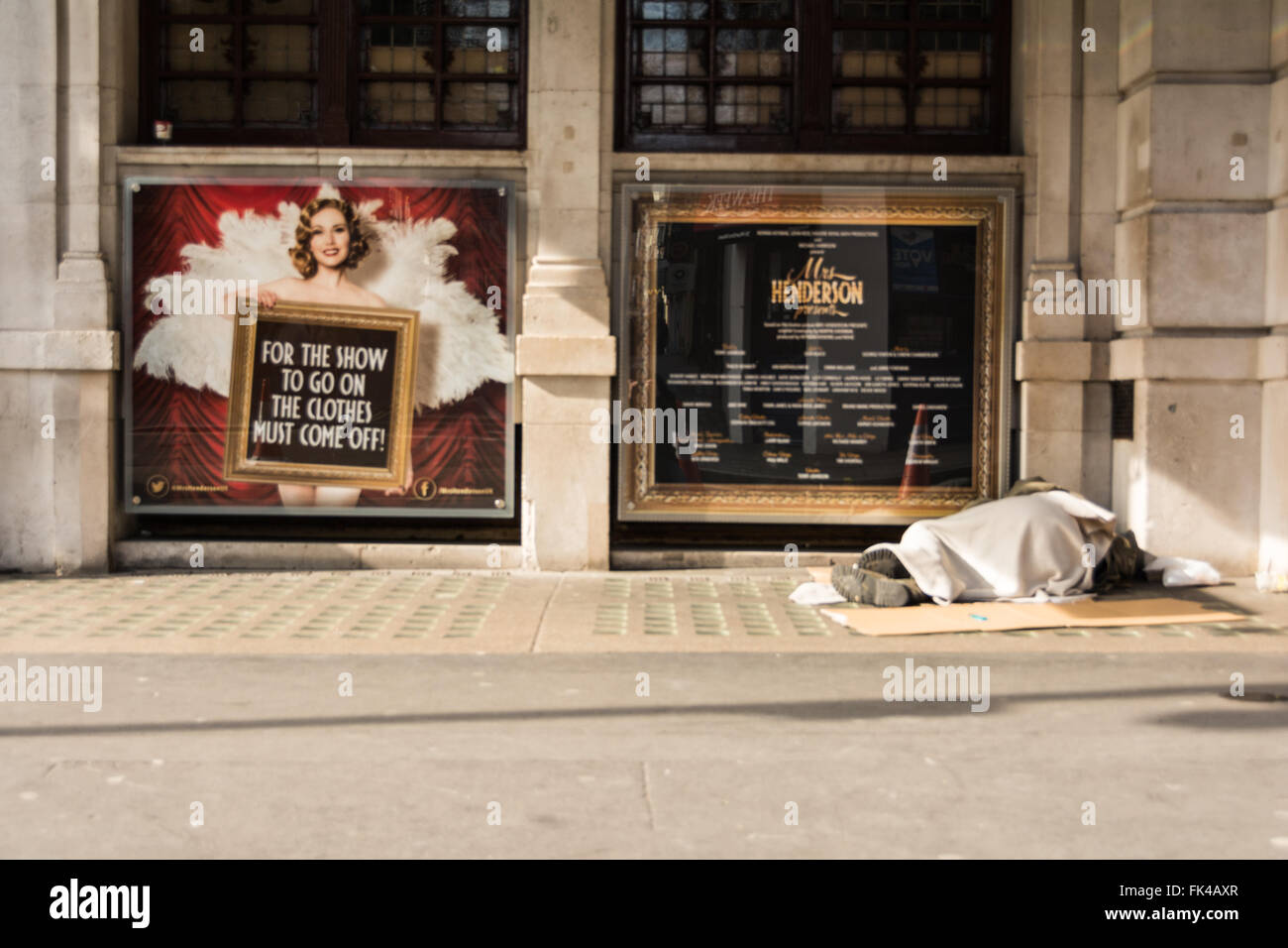 Homeless man sleeping on a doorstep outside a London theatre. Stock Photo