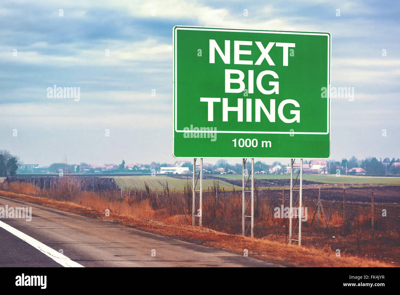 Next big thing ahead conceptual motivational image with road sign by the highway, retro toned image with selective focus Stock Photo