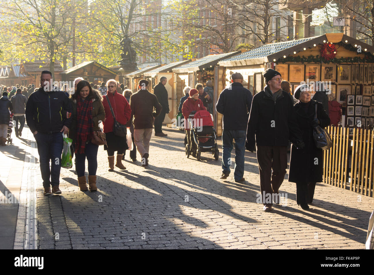 Shoppers in St. Annes Square Manchester enjoying the winter sunshine. Stock Photo