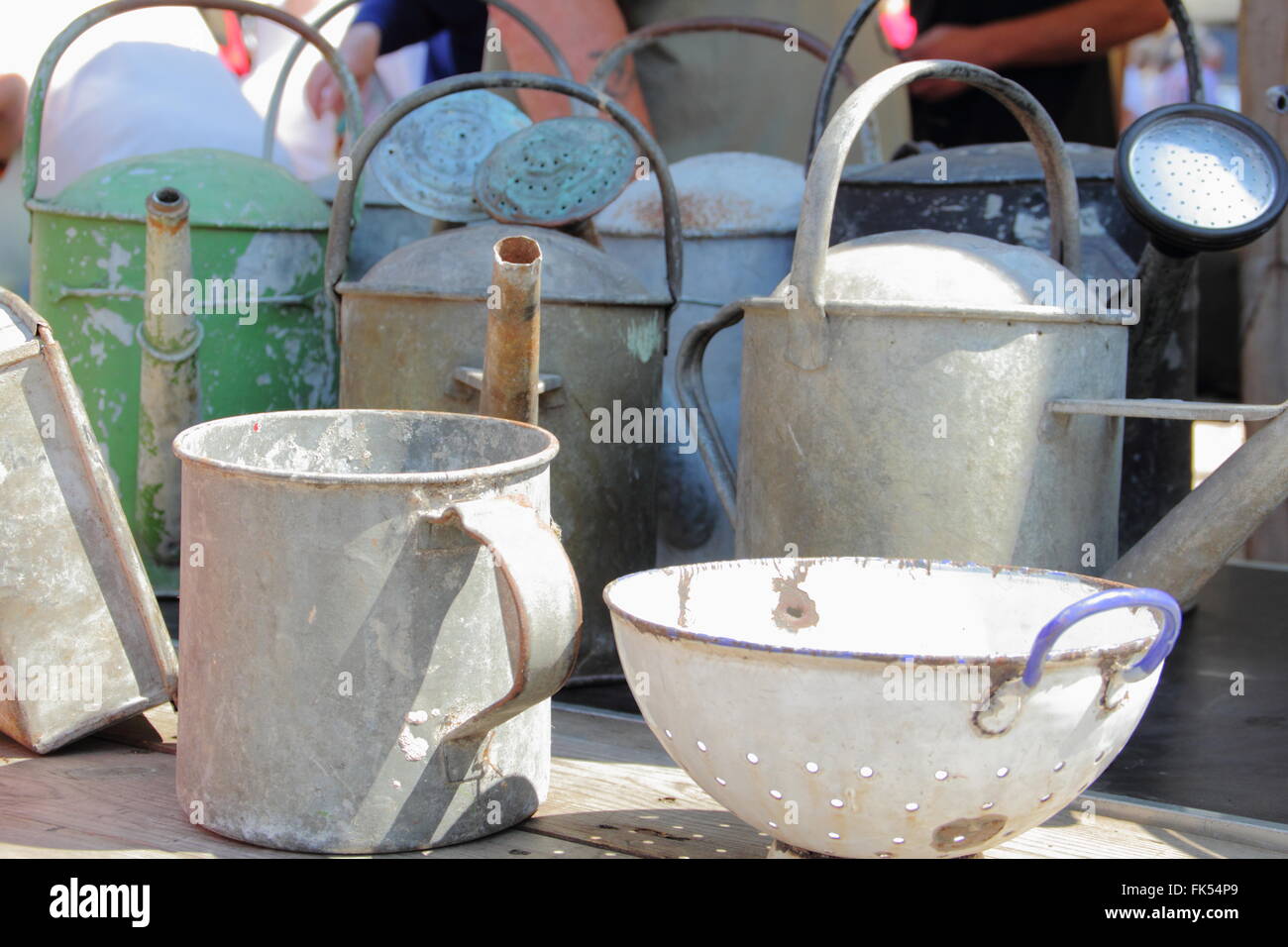 Vintage metal watering cans for sale at a flea market in Chesterfield town centre, Derbyshire, England UK Stock Photo
