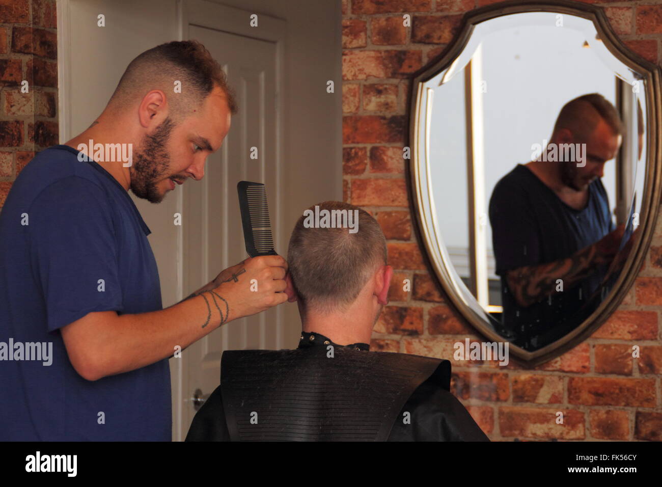 A man has his hair cut at Magnolia Barbering in Chesterfield town centre, Derbyshire UK Stock Photo
