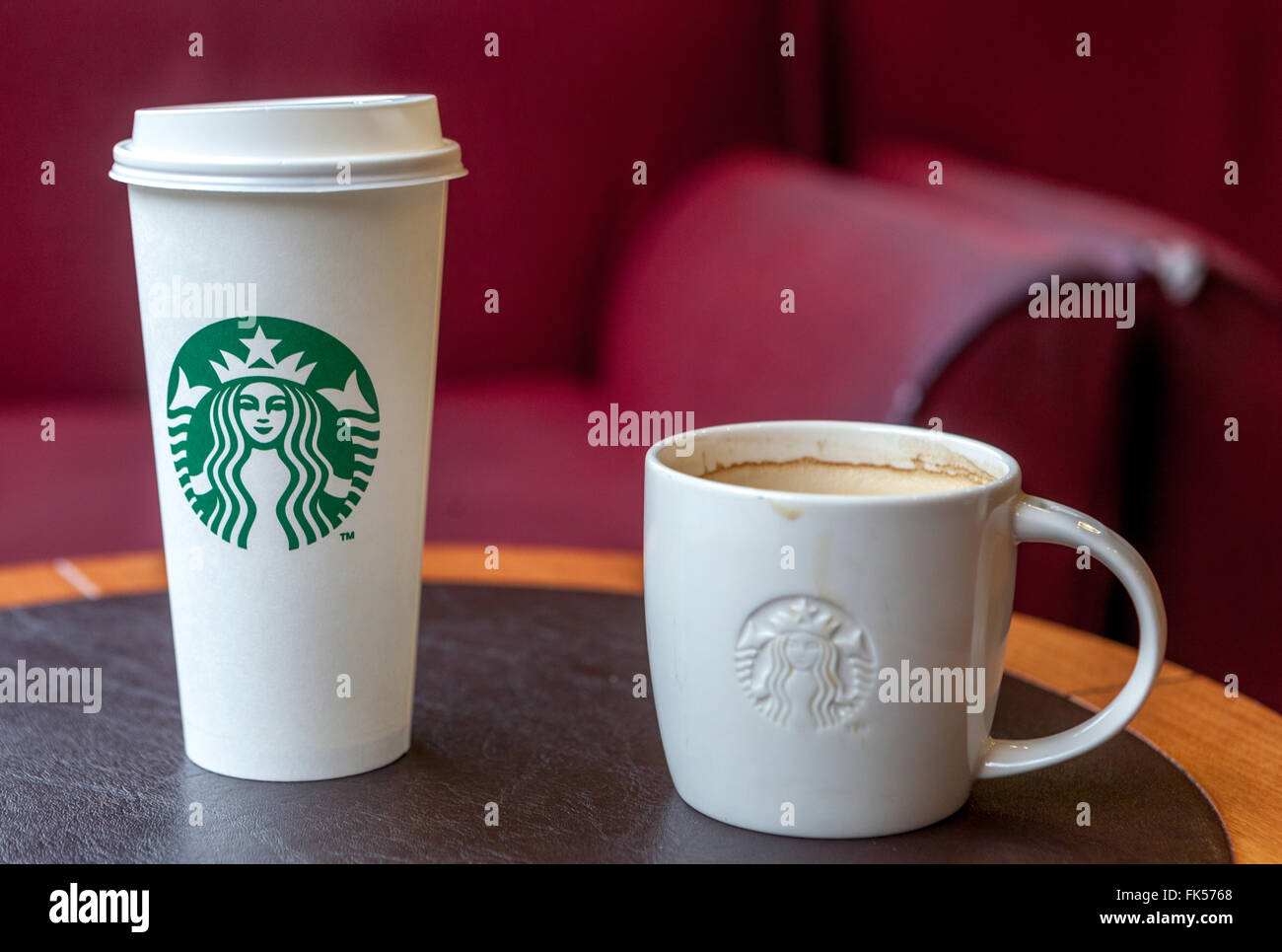 Starbucks coffee cups on a table Stock Photo