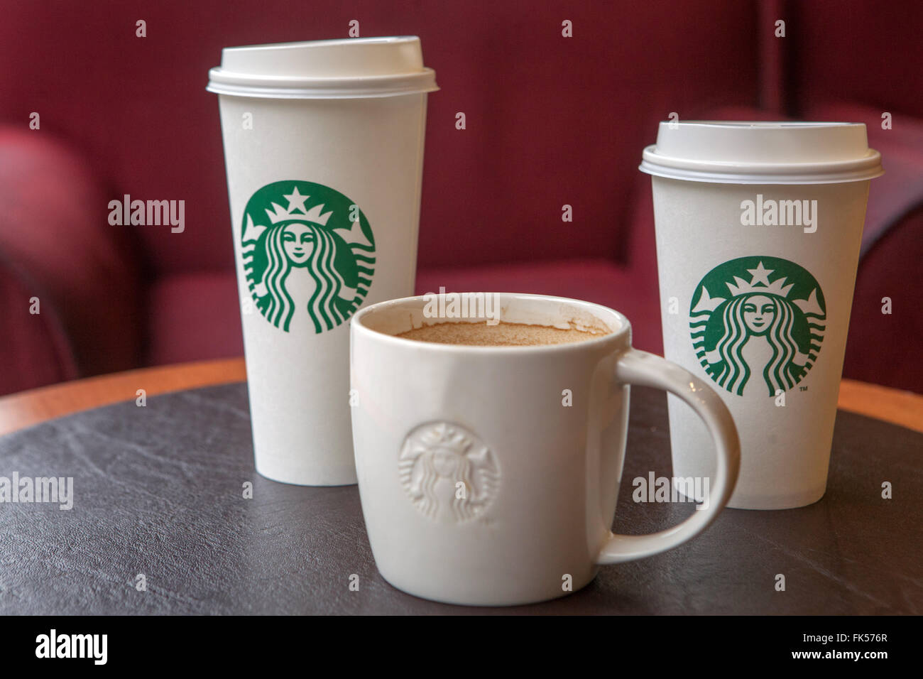 Starbucks coffee cups on a table Stock Photo