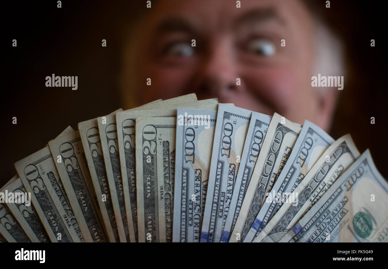 Man poses with US bank notes Stock Photo