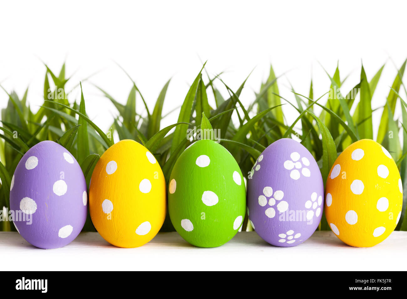 Row of Easter eggs on grass Stock Photo