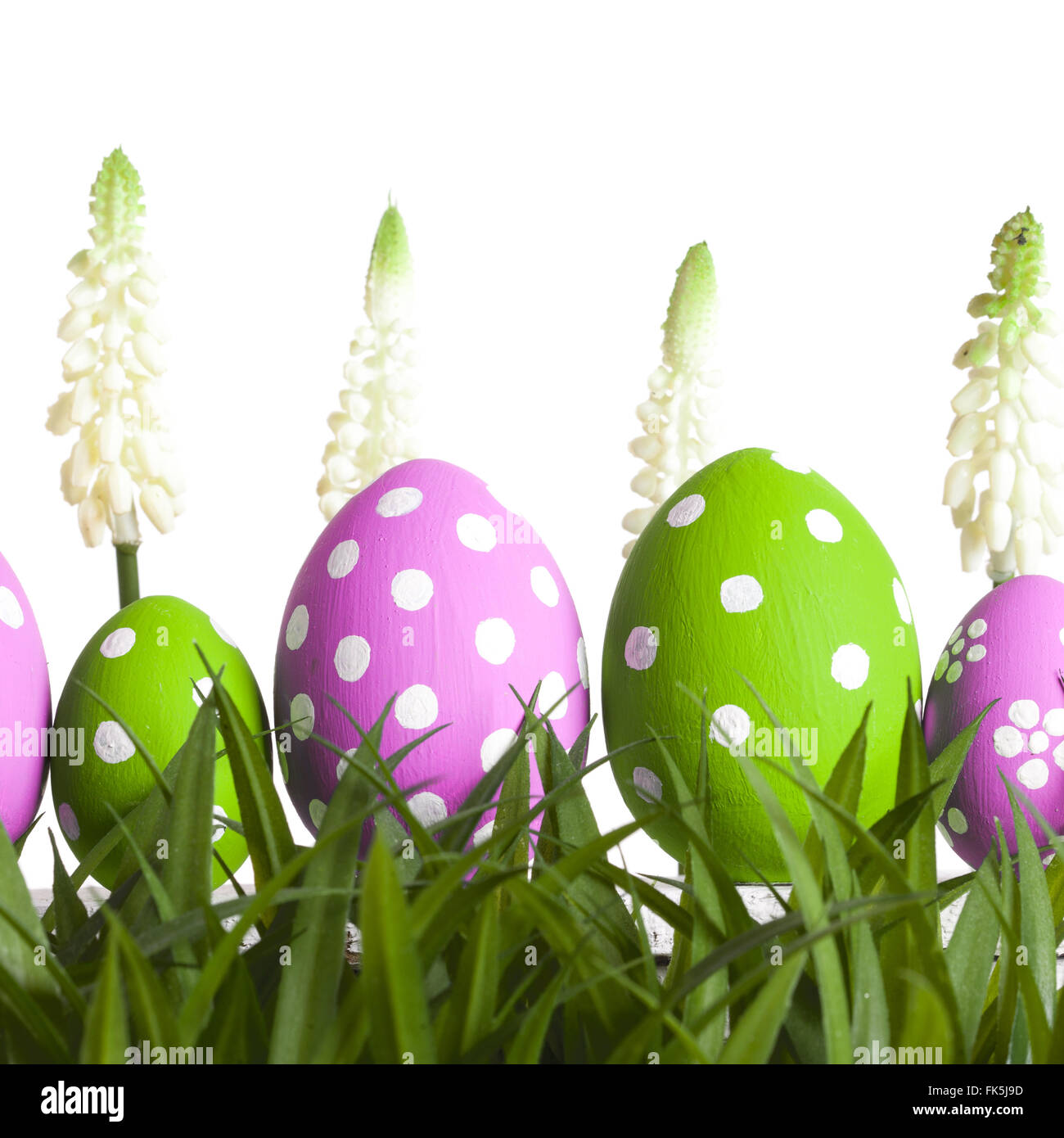 Row of Easter eggs on grass Stock Photo