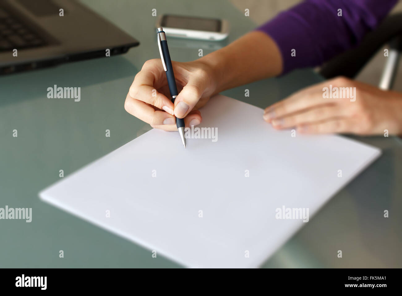Businesswoman write with pen on blank paper in office Stock Photo
