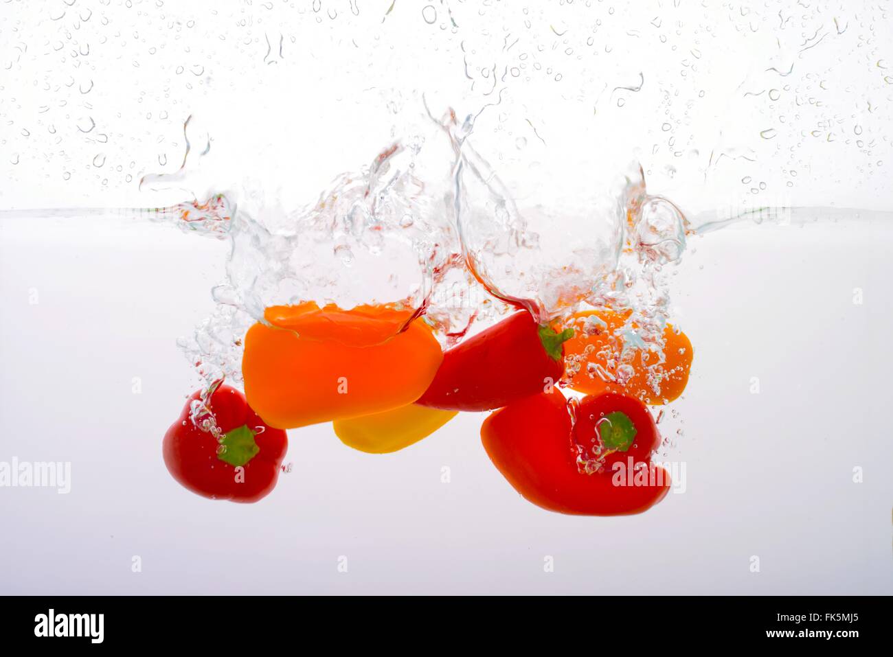 Small Peppers smashed into Water Stock Photo