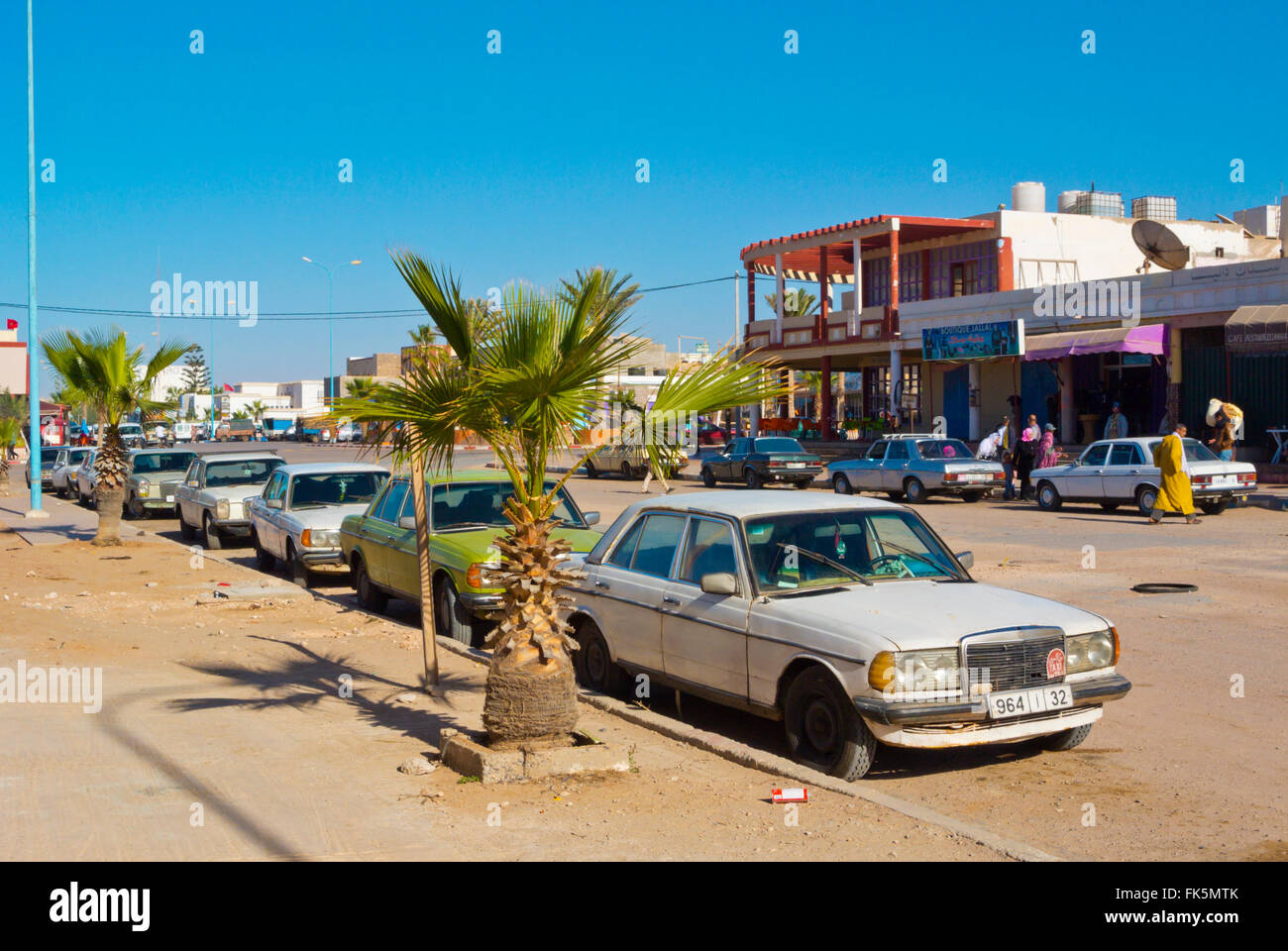 Grand taxis on Avenue Hassan II, main street, Tan Tan Plage, southern Morocco, northern Africa Stock Photo